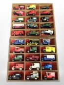A collection of Days Gone diecast delivery vans on two wooden shelves.