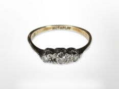 An antique 18ct yellow gold and platinum set three stone diamond ring, size K.