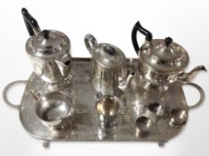 A silver-plated three-piece tea service on etched twin-handled serving tray,