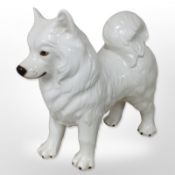 A large ceramic figure of a samoyed dog, length 58cm.