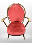 An Ercol spindle back armchair in red dralon
