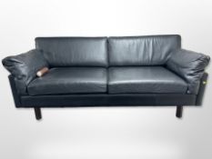 A contemporary Scandinavian black stitched leather three-seater settee,