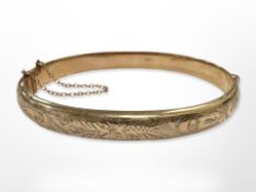 A 9ct yellow gold bangle, diameter 7 cm x 6 cm CONDITION REPORT: 10.1g.