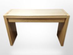 A contemporary oak veneered desk with glass top,