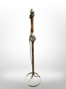 A contemporary wrought metal standard lamp,