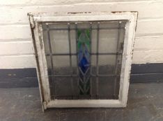 A painted metal framed stained glass window overall 46 cm x 52 cm