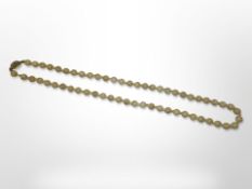 An antique mutton fat jade beaded necklace with silver gilt clasp,