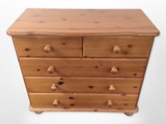 A contemporary pine five drawer chest,