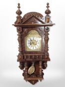 An early 20th century walnut eight day wall clock in bobbin turned case,