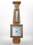 A carved oak barometer,