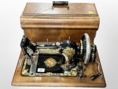 An antique Jones sewing machine in box