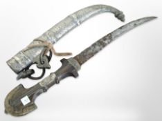 A Jambiya knife in decorative sheath.