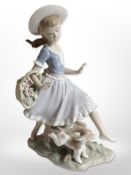 A Lladró figure of a girl and a puppy.