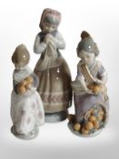 Two Lladró figures of girls carrying oranges, and a further figure of a girl, tallest 22cm.