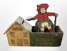 A painted wooden novelty money bank, width 30cm.