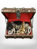 A wooden jewellery trunk containing costume jewellery