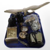 A brass figure of an eagle perched on branch, together with a pair of Soviet binoculars,