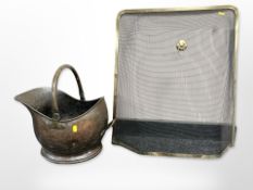 A Victorian copper coal helmet and brass fire guard