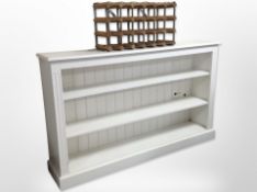 A painted open bookcase 153 cm wide x 31 cm deep x 92 cm high together with a bottle rack