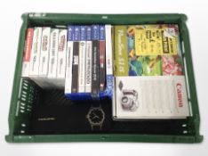 A Canon digital camera, a smart wristwatch in box, several Nintendo DS and PS4 games.