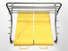 A contemporary metal wall shelf and a parking mat in box