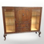 A figured walnut glazed drinks cabinet on pad feet,