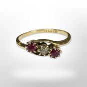 An 18ct yellow gold two stone ruby and diamond ring, size N. CONDITION REPORT: 2g.