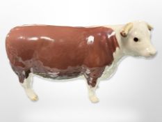 A Beswick cow, 'Ch. of Champions', length 16.5cm.