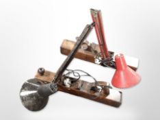 Two vintage anglepoise lamps mounted on wood working planes,