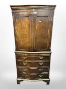 A reproduction mahogany serpentine front drink's cabinet,