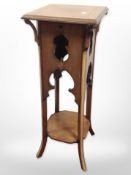 An early 20th century inlaid mahogany plant stand,