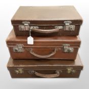 Three graduated early-20th century brown leather cases.