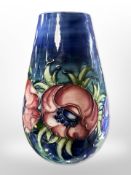 A Moorcroft bulbous vase on dark blue ground, height 18.5cm.