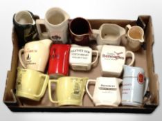 A collection of ceramic whisky jugs bearing various advertising.