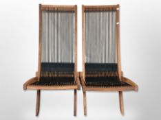 A pair of contemporary teak framed folding chairs with rope seats,