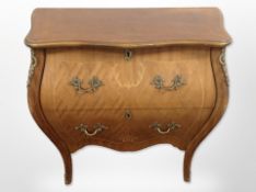 A Continental Kingwood veneered two drawer bombe chest,