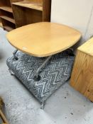 A footstool on chrome legs,