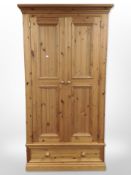 A contemporary pine double door wardrobe,