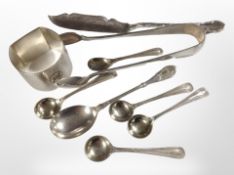 A silver napkin ring with engine-turned decoration, together with a group of silver spoons, a knife,