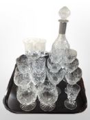 A crystal decanter with plated collar together with a quantity of drinking glasses including