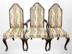 A set of six reproduction mahogany dining chairs on carved pad feet in floral upholstery (two