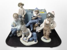 A Lladró figure of a fisher boy, and five further Nao figures including musician, etc.