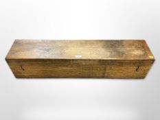 An early 20th century rectangular oak box with metal drop handles,