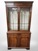 A reproduction mahogany bookcase in George III style, with internal glass shelves,