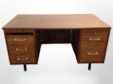 A 20th century teak twin pedestal desk,