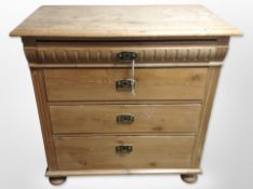 An early 20th century Scandinavian pine four drawer chest on bun feet,