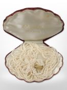 A multi-strand pearl choker with gold-plated clasp.