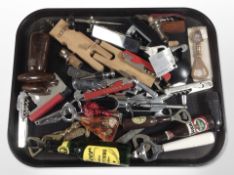 A collection of vintage and modern corkscrews, bottle openers.