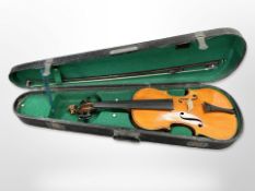A violin with two-piece back, length 14 inches, together with a bow, in an antique wooden box.