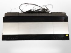 A Bang & Olufsen Beocenter 9300, with leads and remote.